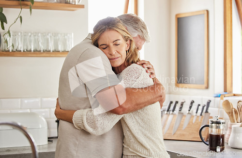 Image of Couple, elderly and hug in kitchen in home together, romance and love. Care, man and woman in retirement love, marriage and embrace in sad moment for support, comfort and unity as married people