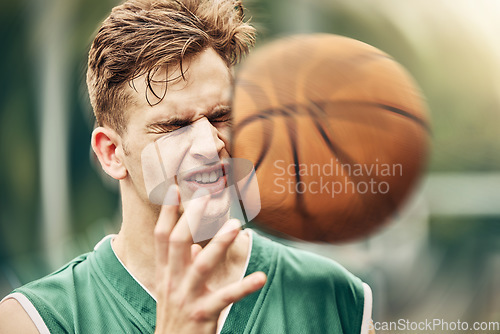 Image of Sports, basketball and accident with face in game match on athlete court for tournament training. Injured man in professional outdoor fitness centre in pain from impact of ball hit action.