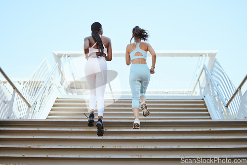 Image of Fitness friends, running steps and women exercise together for healthy lifestyle, wellness and marathon workout in urban outdoors. Back of athletes, runner city training and cardio workout on stairs