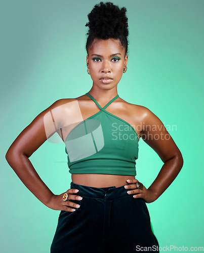 Image of Green fashion, beauty and makeup with a black woman hands on hips in studio on a wall background. Portrait, cosmetics and style with a young female posing for a contemporary style photo shoot