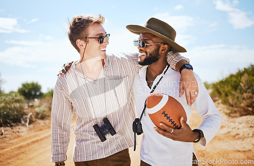 Image of Friends, binoculars and football in a desert with men on a safari tour, bonding and enjoying freedom in nature. Happy, diversity and explore with diverse people laughing, hug and travel together