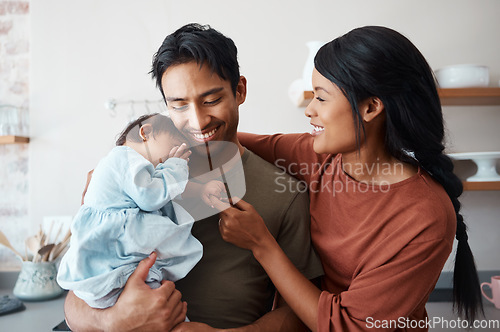 Image of Love, baby and happy parents bonding and caring for their infant child in their comfy home. Happiness, smile and care with an interracial family, man and woman standing together in New york house