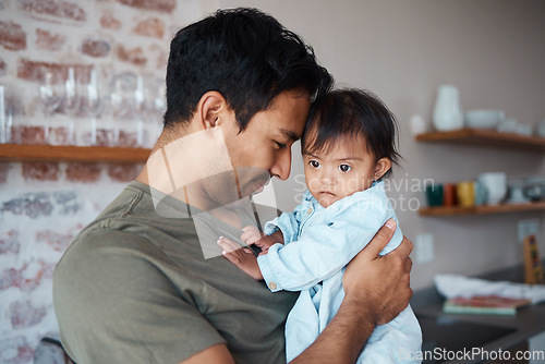 Image of Baby, father and love while bonding and sharing a precious moment between infant girl and dad parent hugging and showing love, care and support at home. Happy man with cute child in their India house