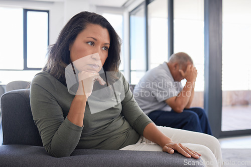 Image of Senior couple stress after conflict, sad news or fight in living room of their home. Elderly man with woman in retirement avoid on sofa with divorce, frustrated, angry or depressed problem in house