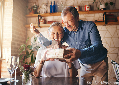 Image of Love, couple elderly and gift to celebrate anniversary on date with smile, happy and excited together. Romance, mature man and older woman exchange present relax, being loving and bonding at home.