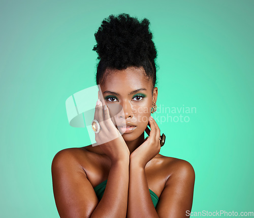 Image of Fashion, beauty and makeup with a black woman or model in studio on a green background for empowerment and equality. Cosmetics, hands and trendy with a beautiful female touching her beautiful face