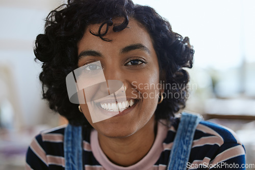 Image of Face, portrait and happy with a young woman feeling carefree or cheerful with a smile closeup. Head, teeth and nosering with an attractive, trendy or edgy female with a piercing on a blur background