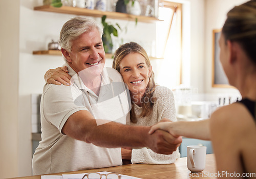 Image of Handshake, advice and finance with a senior couple planning financial savings or investment with a broker at home. Banking, portfolio and retirement with an elderly man and woman managing growth