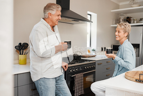 Image of Senior couple, coffee and talking in kitchen with mug, beverage or drink at home. Retirement, smile and elderly happy man and woman drinking tea speaking, discussion or communication in house.