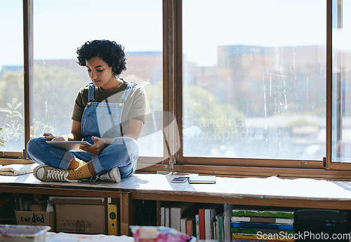 Image of Tablet, creative woman and on table and at window using digital device for social media apps, texting and chatting during break. Girl artist or female student browse online, play game and relax.