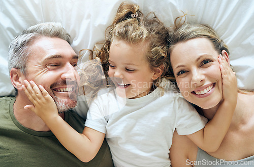 Image of Family, happy and smile of people from above in bed at home relax in a bedroom. Mother, girl and man with happiness together in a house with love, care and calm smiling with a positive mindset