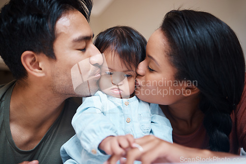 Image of Love, disability and down syndrome parents kiss special needs kid with appreciation. Mom, dad and disabled baby in Puerto Rico home with happy and caring family bonding together.