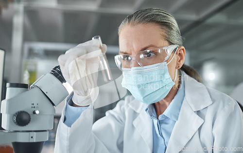 Image of Covid lab, medical science and scientist working on futuristic medicine research for healthcare at a pharmacy. Doctor doing an expert chemical test on liquid for innovation while at a hospital