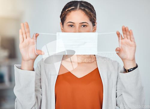 Image of Business woman, portrait and mask in end of covid taking off face protection against blurred background. Female employee free from corona virus holding and stretching masks of ending or stop pandemic