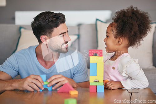 Image of Children, family and education with a girl and her father playing with building blocks in the living room of their home. Love, learning and toys with a foster parent and adopted child together