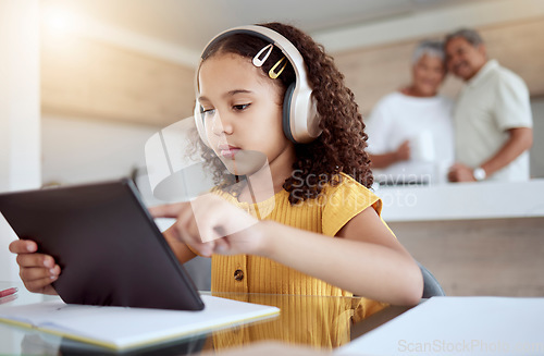 Image of Girl, tablet or headphones in homeschool, education or homework learning on notebook in senior grandparents house. Thinking student, child or study technology and lockdown music podcast with elderly