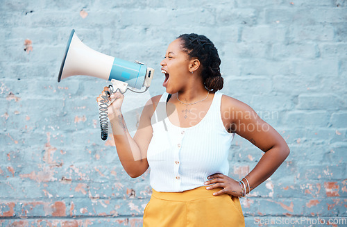 Image of Black woman, megaphone speaker and announcement on wall background for speech, protest and angry voice. Feminist rally fight for human rights, justice and freedom, gender equality, society and news