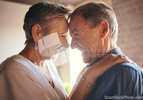 Image of Love, happy and laugh elderly couple hug and bond in their home together, cheerful and sharing a funny joke. Humour, care and affection by senior man and woman enjoying retirement and playful fun