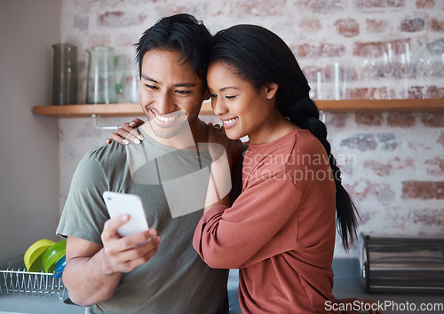 Image of Asian couple, phone or bonding hug in house or home kitchen with communication technology, social media app or internet news. Smile, happy and love man and relax woman with mobile for zoom video call