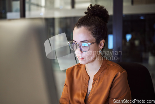 Image of Woman, reading and glasses reflection in office at night, working on computer email or planning business schedule. Female worker, pc tech screen and overtime web research in dark company workplace.