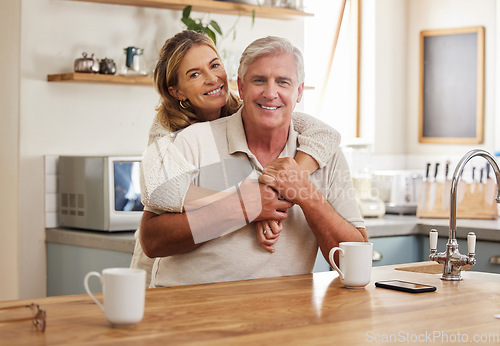 Image of Senior couple, smile and love while hugging in kitchen drinking coffee, relax and bonding feeling happy, support and trust. Portrait of old Australia man and woman in healthy relationship or marriage