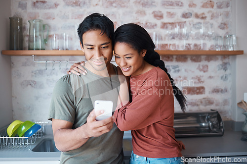 Image of Couple, smile and phone in kitchen for social media, meme or comic video on web. Man, woman and happy with smartphone while reading funny blog, chat or news on app while relax together in home