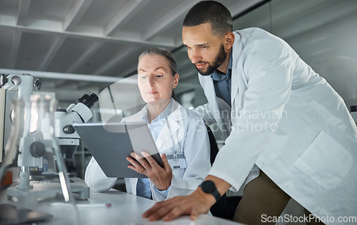 Image of Science teamwork, tablet and scientist in digital research analysis, investigation or check medical software analytics in laboratory. Healthcare innovation biotechnology expert people reading report