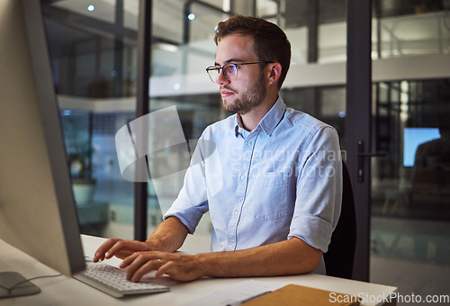 Image of Night worker, businessman and computer planning, working and typing online project proposal, email or trading report. Focus young employee, desktop website and strategy ideas in dark marketing agency