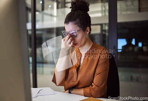 Image of Stress, burnout and woman with a headache tired from working overtime at her office desk due to paperwork deadlines. fatigue, mental health and overwhelmed administrator frustrated with a migraine