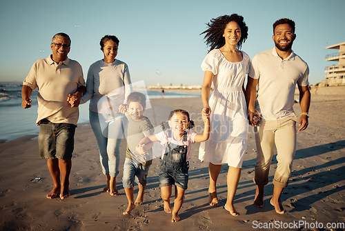 Image of Portrait of happy family with little kids walking together on beach during sunset. Adorable little children bonding with mother, father, grandmother and grandfather outdoor on summer vacation
