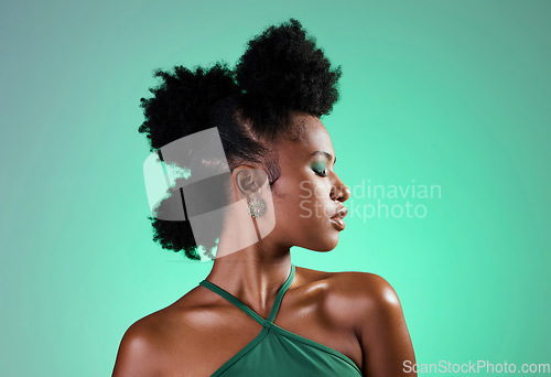 Image of Black woman, green makeup and face on skin for beauty, fashion and cosmetics against backdrop. Model, girl and hair, show afro, eyeshadow and lips in portrait with studio background in New Orleans