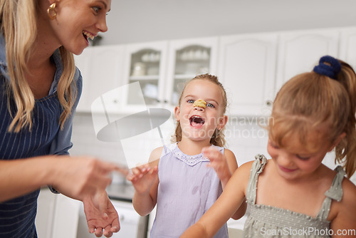 Image of Home kitchen, children play while cooking with happy mother and funny family time learning to bake. Crazy girl child with flour dough on nose, laugh together helping mom smile and sweet kids have fun