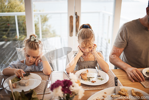 Image of Picky eating kids frustrated with lunch food, fussy at dinner table and struggle in family home with diet. Mad, moody and upset young girl children refuse to eat disgusting, dislike and annoyed meal