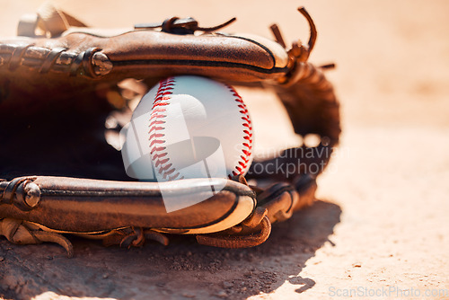 Image of Baseball, sport and exercise with a ball and glove on a base plate on a pitch or field outdoor for a competitive game or match. Fitness, sports and skill with equipment on the ground for training