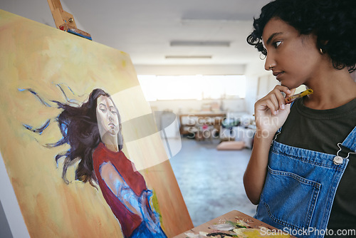 Image of Creative woman, thinking about her art, and looks at painting in studio for exhibition. Professional Indian painter, artist with paint brush, search for inspiration for work on canvas.