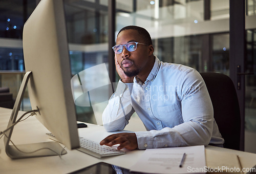 Image of Tired, burnout businessman on computer at night in a dark office working on company finance management. Sad, mental health and depression corporate accountant with glasses and tax or audit paperwork