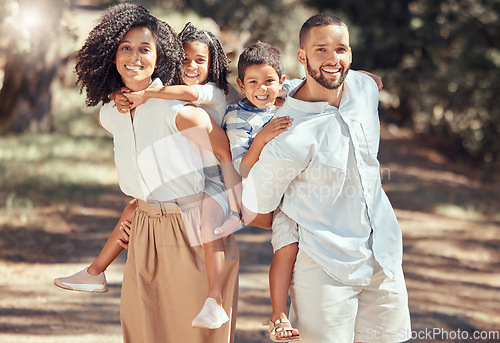 Image of Portrait of happy family bonding in a park, having fun and being playful on peaceful walk in nature together. Relaxed parents enjoy time with kids and moments of parenthood while showing affection