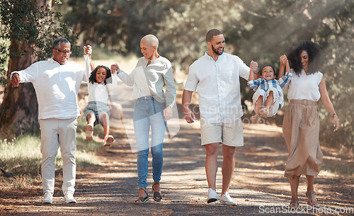 Image of Big family walking in park holding hands for love, support and care on summer travel vacation in forest nature. Wellness, health and child development with grandparents and children or kids in woods