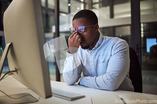 Image of Headache stress, work burnout and businessman working on corporate strategy on the internet in a dark office at night. Corporate employee doing overtime with a migraine, problem and computer glitch