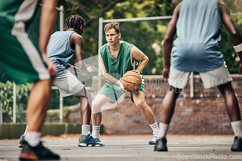 Image of Basketball, team sport and competition for male athletes and players in training or professional match on an outdoor fitness court. Diversity, competitive and skill of men playing a ball game in USA