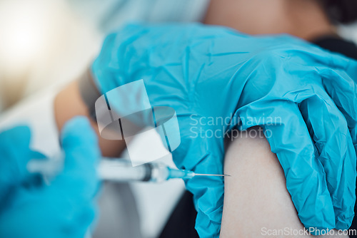 Image of Vaccine, covid and healthcare with a doctor and patient in the hospital for an injection, treatment or cure. Hands, needle and syringe with a health professional injecting medicine into an arm