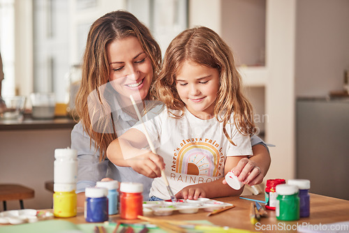 Image of Mother, girl and painting art in house studio, home or creative space with brush, oil paint or palette. Happy smile mom, child or kid bonding in relax design or class activity for adhd or autism help