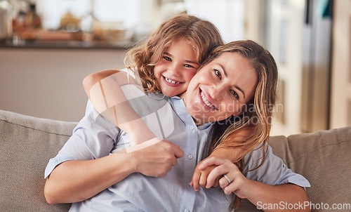 Image of Girl, mother and sofa show love in home, happy and smile together in living room. Mom, child and couch show happiness, hug and relax in school holiday in portrait at family home in Dallas, Texas