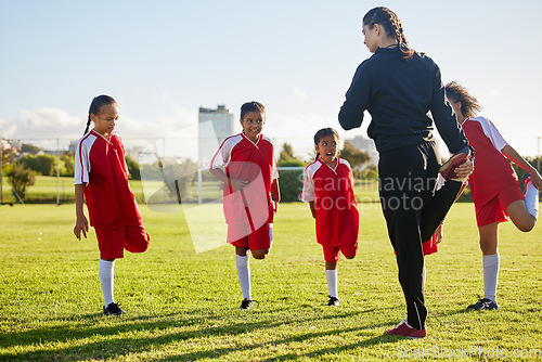 Image of Team, soccer and girls stretching in football stadium with coach in training, sports and group warm up together. Healthy, teamwork and young school children doing exercise with fitness instructor