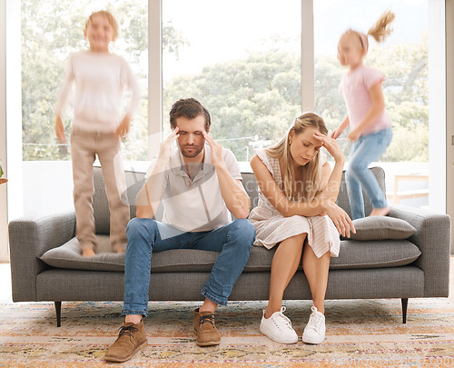 Image of Stress parents, kids and jump on sofa in living room child problem for tired, sad and overworked mom and dad at home. Burnout, unhappy and sad mother and father on lounge couch with trouble children