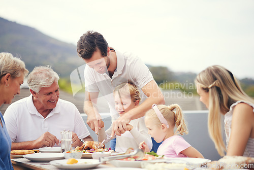 Image of Thanksgiving lunch, big family and dad turkey carving outdoor with food and happy people. Father, senior grandparents and children with a happiness smile on a balcony table ready to eat with the kids