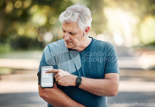 Image of Senior man, phone band and fitness with music earphones in nature park, environment or Australian garden. Mature runner with 5g mobile technology for radio playlist, exercise training and workout app