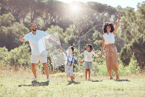 Image of Happy family, kids and walking in nature holding hands, spending vacation time together and bonding. Love, man and woman, children and outdoors park, forest or countryside walk with care and smile.