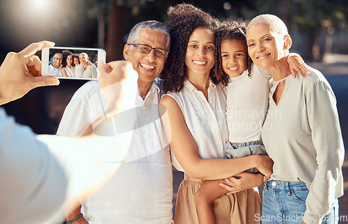 Image of Phone, screen and happy family relax and smile while posing for a picture outdoors together, loving and embracing. Child, mother and grandparents bonding on a trip in nature, hug and enjoy summer