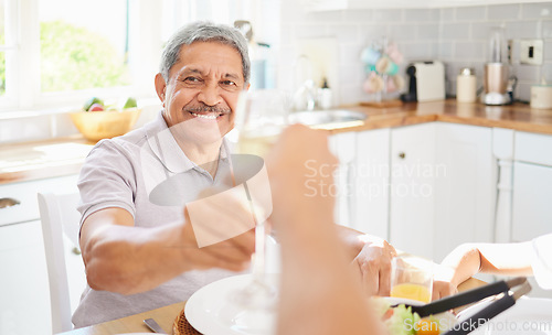 Image of Champagne, glass and senior couple man for birthday celebration in Mexico home kitchen. Happy elderly people celebrate holiday with alcohol wine, eating lunch or brunch together for retirement wealth